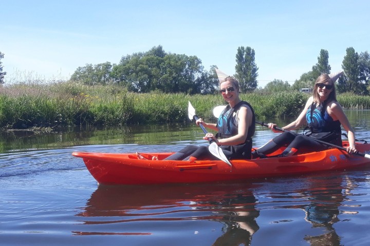 a person riding on the back of a boat in the water